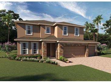 Two-story house with stone accents and a two-car garage, landscaped lawn at 4158 Gooseberry Trl, Kissimmee, FL 34746