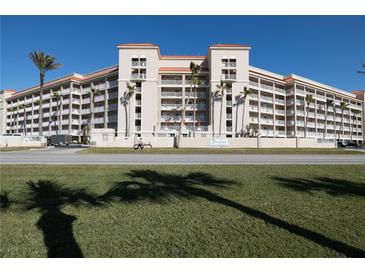 Sunbay condo building, featuring multiple stories, balconies, and palm trees at 5501 S Atlantic Ave # 4150, New Smyrna Beach, FL 32169