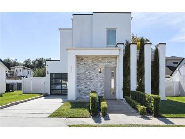 Modern two-story home with gray stone accents and landscaped lawn at 830 W Canton Ave, Winter Park, FL 32789