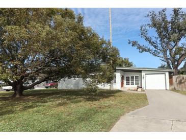 Ranch style home with carport and mature landscaping at 913 Carlson Dr, Orlando, FL 32804