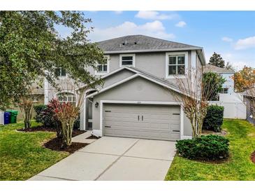 Two-story house with gray siding, attached garage, and well-manicured lawn at 1105 Harbor Hill St, Winter Garden, FL 34787