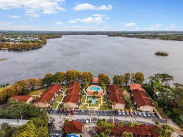 Aerial view of waterfront condo community with pool and parking at 1174 Paseo Del Mar # D # 32707, Casselberry, FL 32707