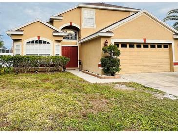 Two-story house with a two-car garage and well-maintained lawn at 196 Westmoreland Cir, Kissimmee, FL 34744