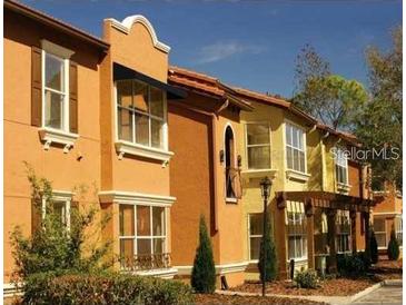 Attractive row of townhouses with Spanish-style architecture at 5112 Conroy Rd # 13, Orlando, FL 32811