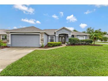 Charming single-story home with a well-manicured lawn and inviting double-door entrance at 707 Terranova Ave, Winter Haven, FL 33884