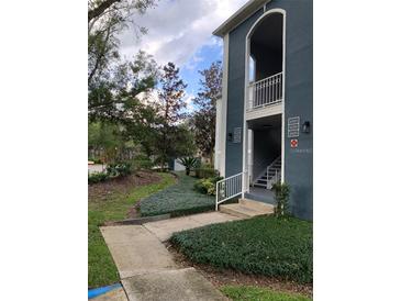 Building entrance with stairs and well-maintained landscaping at 8203 Olympia Ct # 8203, Longwood, FL 32779