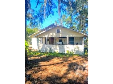 One-story house with front porch, needs some landscaping at 1303 Stowe Ave, Mount Dora, FL 32757