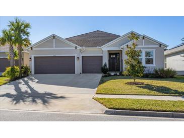 Two-story house with a two-car garage and landscaped lawn at 1440 Waterview Ridge Cir, Apopka, FL 32703