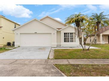 One-story house with a two-car garage and landscaped yard at 1820 Putney Cir, Orlando, FL 32837