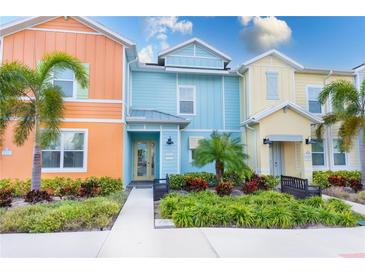 Three colorful townhouses with landscaping and walkways at 2904 On The Rocks Pt, Kissimmee, FL 34747