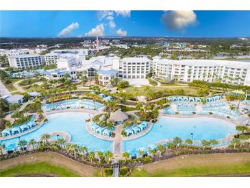 Large resort pool with multiple lounging areas at 2904 On The Rocks Pt, Kissimmee, FL 34747