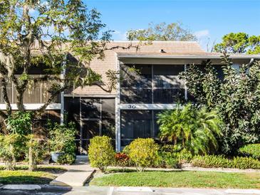 Condo building exterior with lush landscaping and a walkway at 30 Sheoah Blvd # 18, Winter Springs, FL 32708