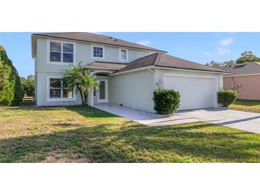 Two-story house with a two-car garage and a well-manicured lawn at 3170 Santa Cruz Dr, Kissimmee, FL 34746