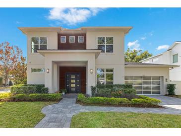 Two-story modern home with gray exterior, dark wood accents, and landscaped lawn at 400 W Hazel St, Orlando, FL 32804