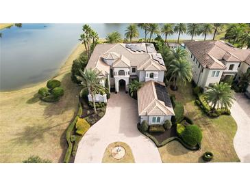 Luxury home with pool and lake views,solar panels, and circular driveway at 4326 Isabella Cir, Windermere, FL 34786