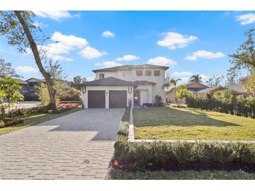 Two-story home with a modern design, two-car garage, and landscaped yard at 6564 Lagoon St, Windermere, FL 34786