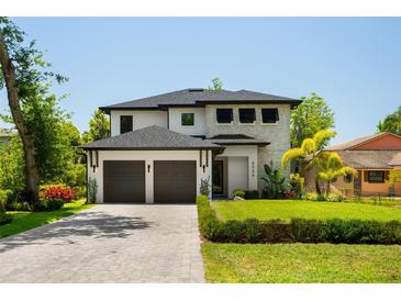 Beautiful two-story home with a well-manicured lawn and a two-car garage at 6564 Lagoon St, Windermere, FL 34786
