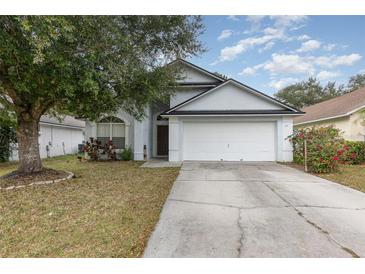 One-story house with a white garage door and landscaping at 711 Archus Ct, Winter Garden, FL 34787