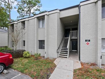 Exterior view of condo building with stairs and parking at 127 Springwood Cir # A, Longwood, FL 32750