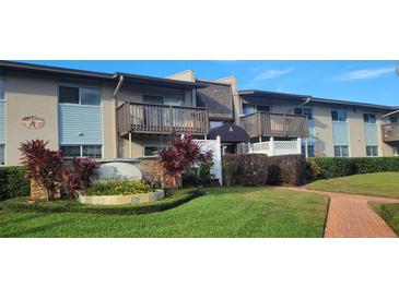 Well-maintained condo building with landscaping and brick pathway at 1695 Lee Rd # A209, Winter Park, FL 32789