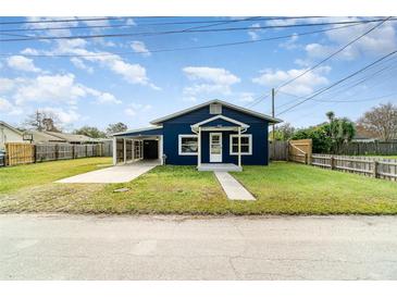 Charming renovated blue house with a carport and fenced yard at 205 9Th St, St Cloud, FL 34769