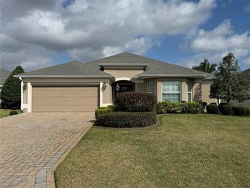 Charming one story home with a well maintained lawn and two car garage at 2544 Ashville Ave, The Villages, FL 32162