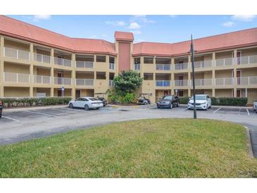 Two-story condo building with parking and landscaping at 6403 Parc Corniche Dr # 4309, Orlando, FL 32821