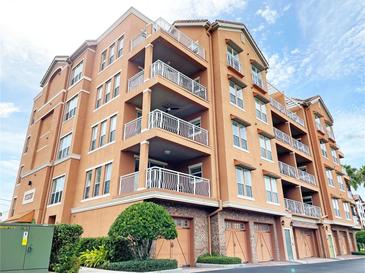 Three-story building with multiple balconies and attached garages at 7580 Toscana Blvd # 834, Orlando, FL 32819