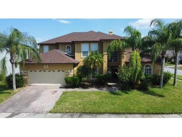 Two-story house with a large yard and a three-car garage at 15937 Birchwood Way, Orlando, FL 32828