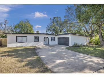 Updated single story home with modern exterior and driveway at 2421 Healy Dr, Orlando, FL 32818