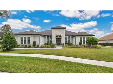 Luxury home with stone accents and a tile roof at 25500 Hawks Run Ln, Sorrento, FL 32776