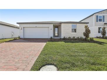 Charming single Gathering home featuring a brick driveway and well manicured green lawn at 4508 Windy Oak Way, St Cloud, FL 34772