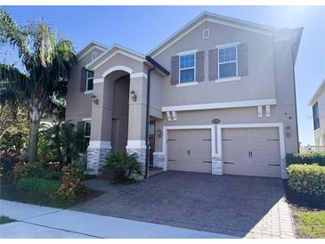 Two-story house with a three-car garage and landscaping at 15306 Southern Martin St, Winter Garden, FL 34787