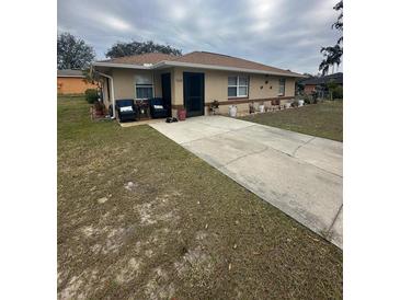 Single-story home with a landscaped yard and driveway at 160 Clay Cut Cir, Haines City, FL 33844