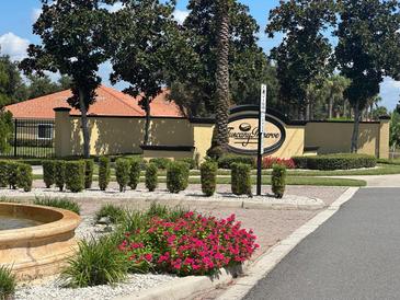 Welcoming entrance to Tuscany Preserve with colorful flowers and lush landscaping at 1617 Cumin Dr, Kissimmee, FL 34759