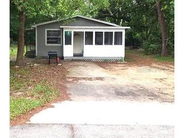 Gray house with screened porch, and a yard at 2204 Suanee Ave, Eustis, FL 32726