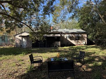 Spacious backyard with patio furniture and mature trees at 2429 S Elm Ave, Sanford, FL 32771