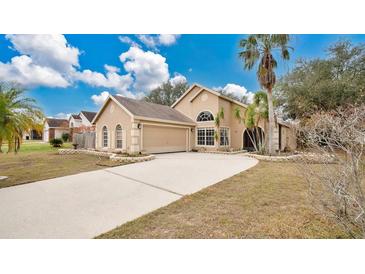 Charming single-story home boasts an attached two-car garage and a long driveway, perfect for Gathering and guests at 905 Hatteras Ave, Minneola, FL 34715