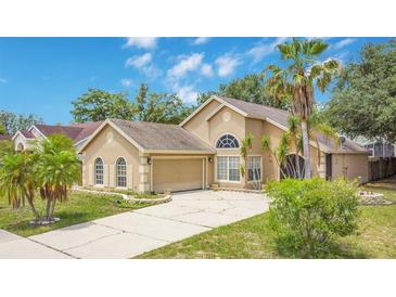 Charming single-Gathering home with well-maintained landscaping and a spacious driveway at 905 Hatteras Ave, Minneola, FL 34715