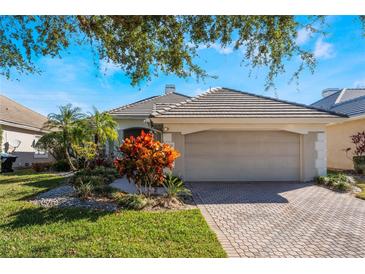 Single-story home with attached garage and well-manicured landscaping at 10812 Woodchase Cir, Orlando, FL 32836