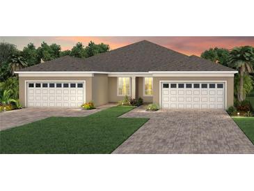 Two-car garage, light beige exterior, and a nicely landscaped front yard at 13563 Pearl Beach St, Winter Garden, FL 34787