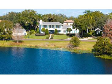 Aerial view of a waterfront home with lush landscaping at 1522 Lake Knowles Cir, Winter Park, FL 32789