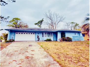 Light blue house with white garage door and landscaping at 1854 Sepalwood Ct, Orlando, FL 32818