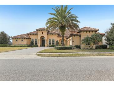 Two-story house with tile roof, palm tree, and driveway at 3764 Farm Bell Pl, Lake Mary, FL 32746