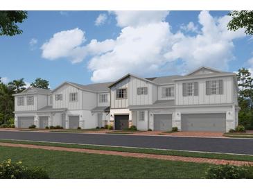 Modern townhome community with attached garages and landscaping at 4303 Campsite Loop, Orlando, FL 32824