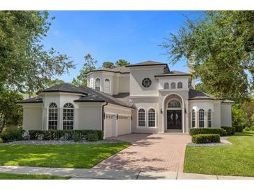 Stunning two-story home with brick driveway and manicured landscaping at 5265 Forest Edge Ct, Sanford, FL 32771
