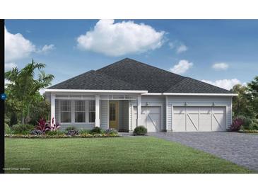 Charming coastal cottage style home with two-car garage and landscaped lawn at 6232 Trailblaze Bnd, St Cloud, FL 34771