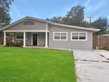 Newly painted house with a well-maintained lawn and driveway at 1142 Grayson Dr, Orlando, FL 32825