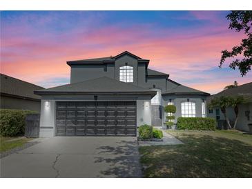 Charming two-story home with a well-manicured lawn, beautiful windows, and a spacious two-car garage at 127 Westmoreland Cir, Kissimmee, FL 34744