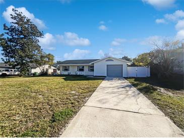 Newly renovated home with a large front yard and driveway at 1375 Sacramento St, Deltona, FL 32725